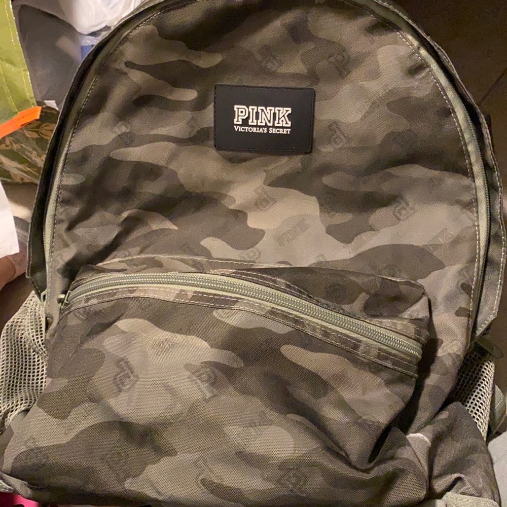 Pink backpack with two big pockets and small front pocket. Water bottle pockets.